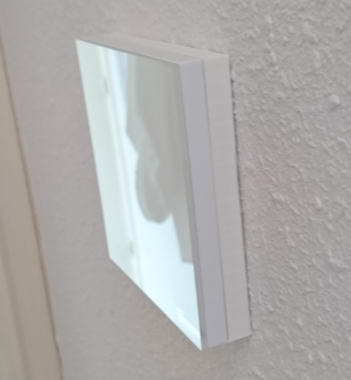 Photo of the Sonoff TX mounted on the spacer with faceplate.