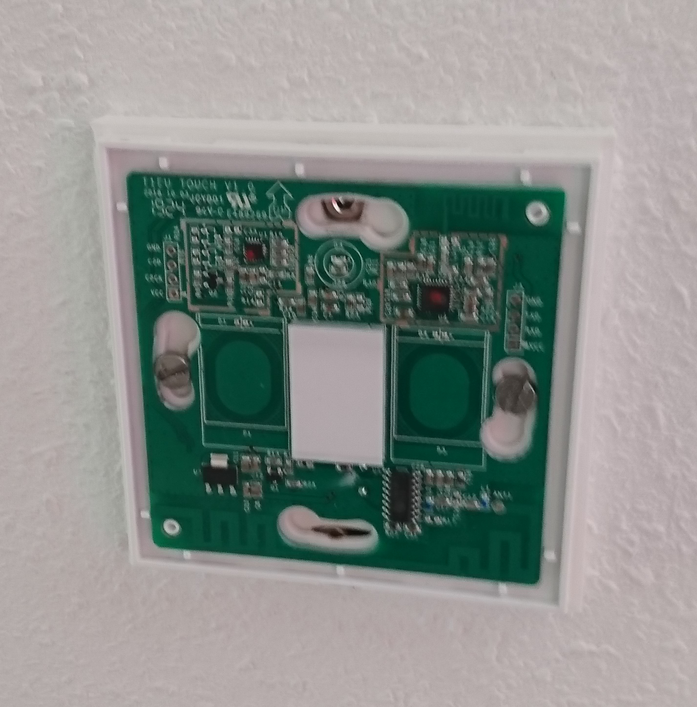 Photo of the Sonoff TX mounted on the spacer without faceplate.